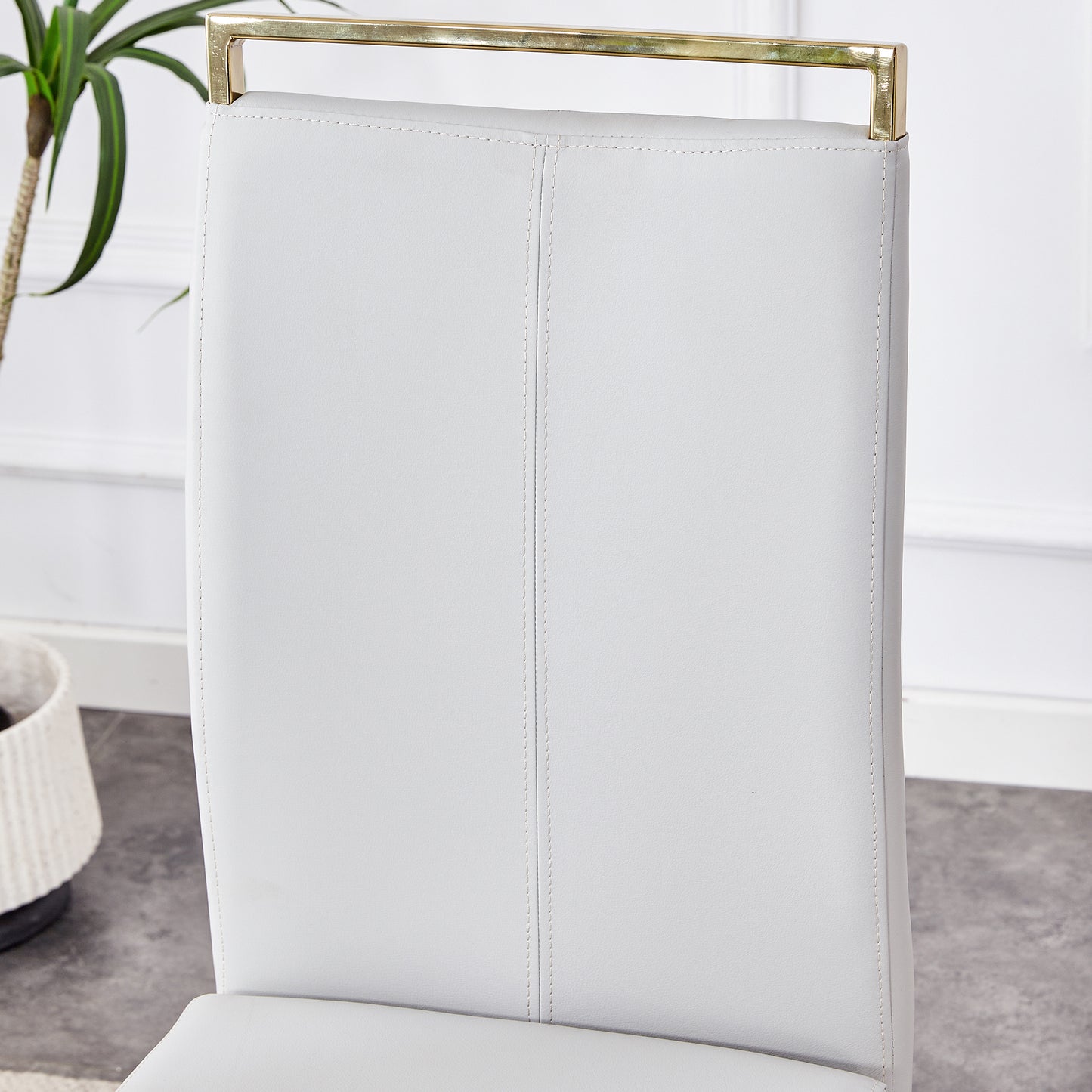 Table and chair set.Large modern rectangular table with 0.4 inch patterned glass tabletop and large MDF table legs.Comes with 6 chairs with faux leather cushioned seats and golden metal legs.