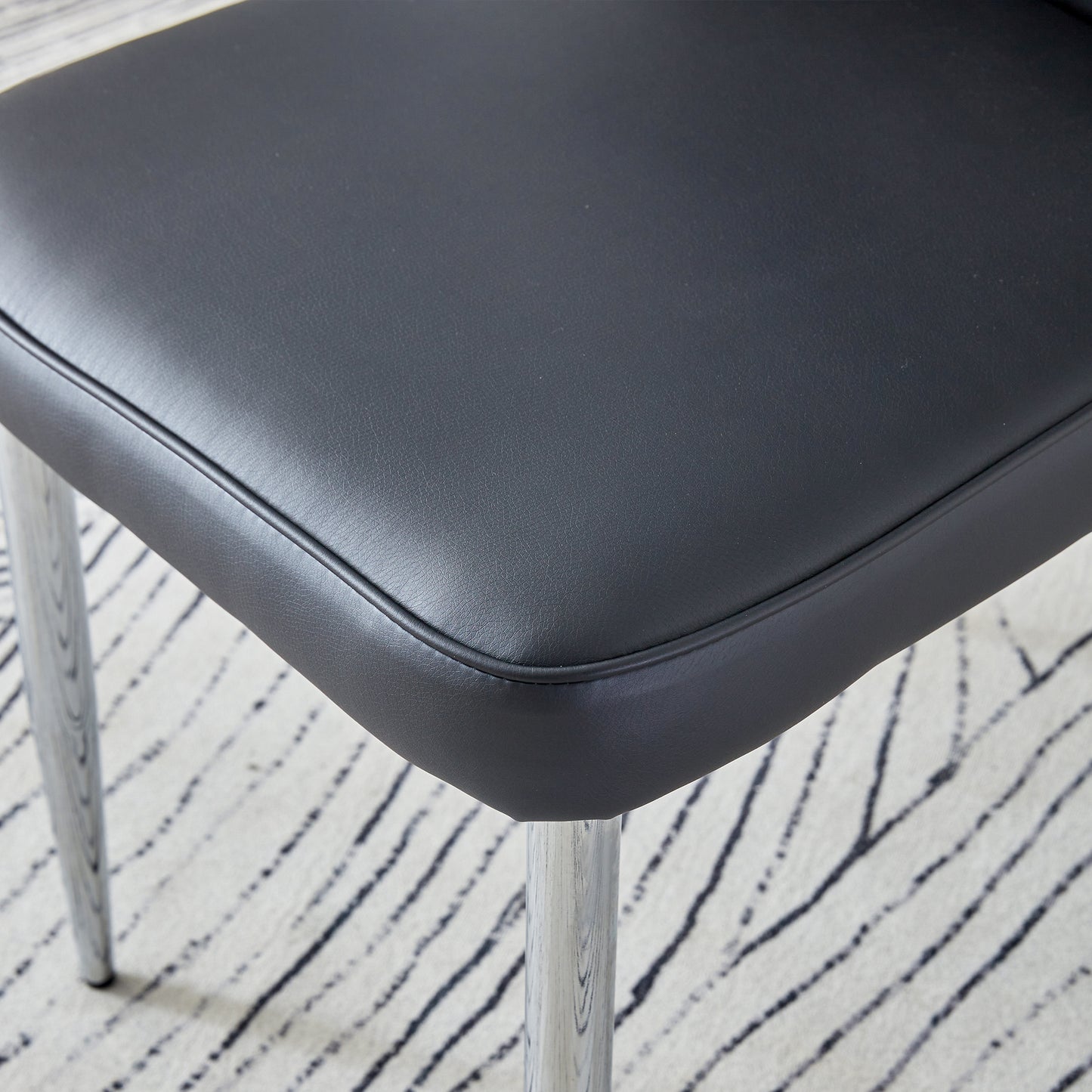 Table and chair set.Elegant Transparent Tempered Glass Dining Set - 71"x35.4" with 6 Black PU Chairs with a vertical stripe design on the backrest.