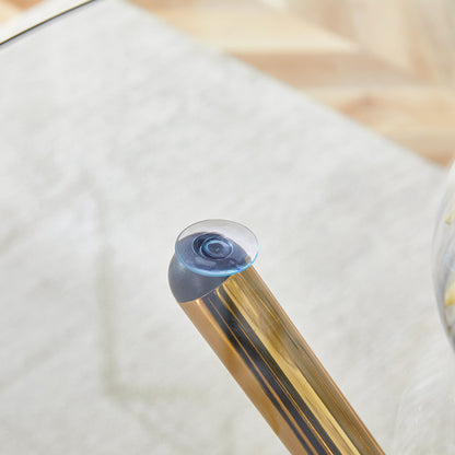 Round clear glass dining table with a unique shape for 4-6 people, with ring-shaped gathered gold metal legs, suitable for desks, kitchens, terraces, dining rooms.