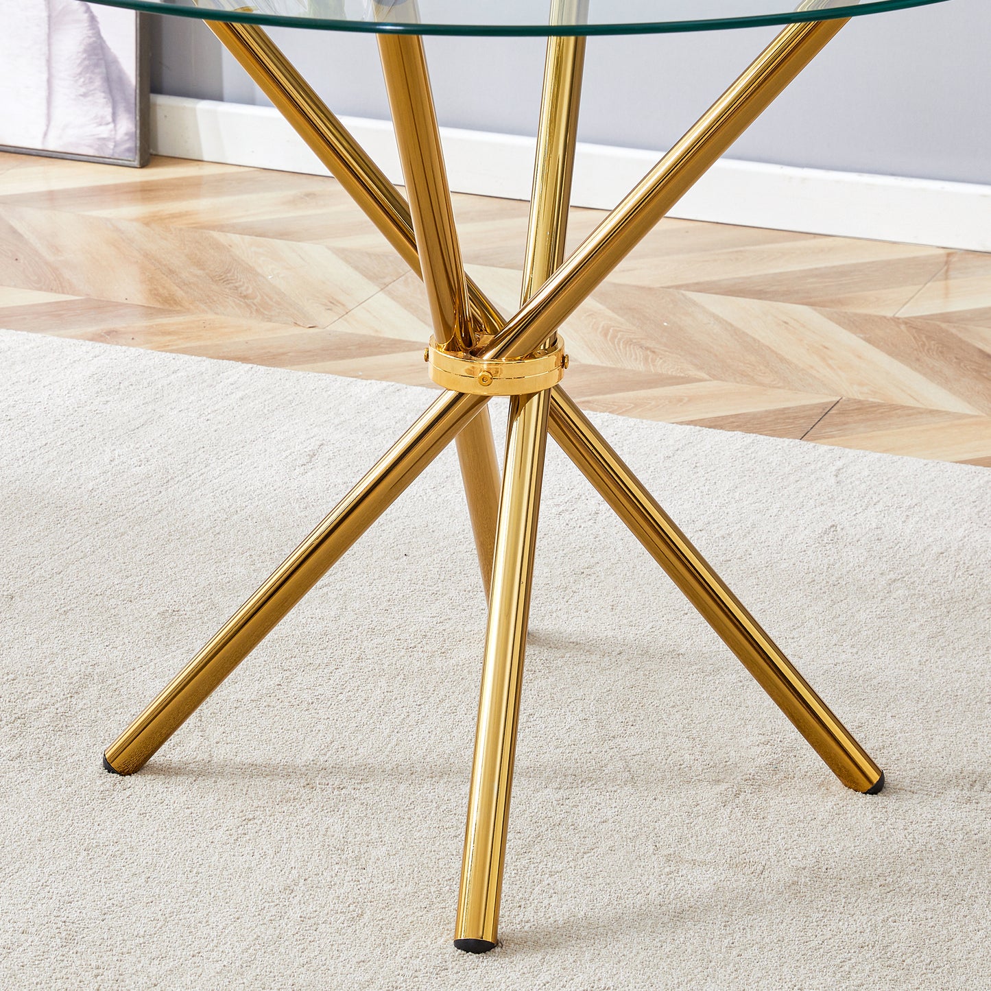 Round clear glass dining table with a unique shape for 4-6 people, with ring-shaped gathered gold metal legs, suitable for desks, kitchens, terraces, dining rooms.