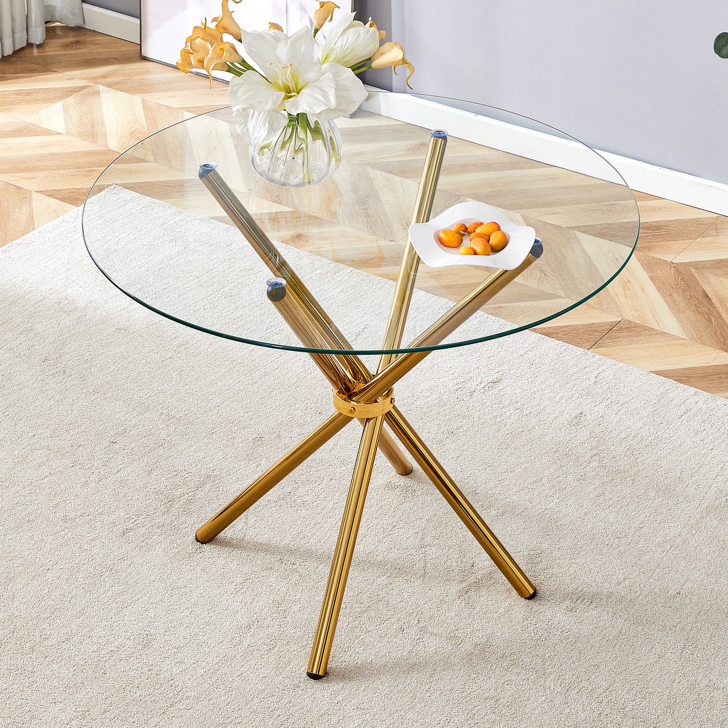 Round clear glass dining table with a unique shape for 4-6 people, with ring-shaped gathered gold metal legs, suitable for desks, kitchens, terraces, dining rooms.